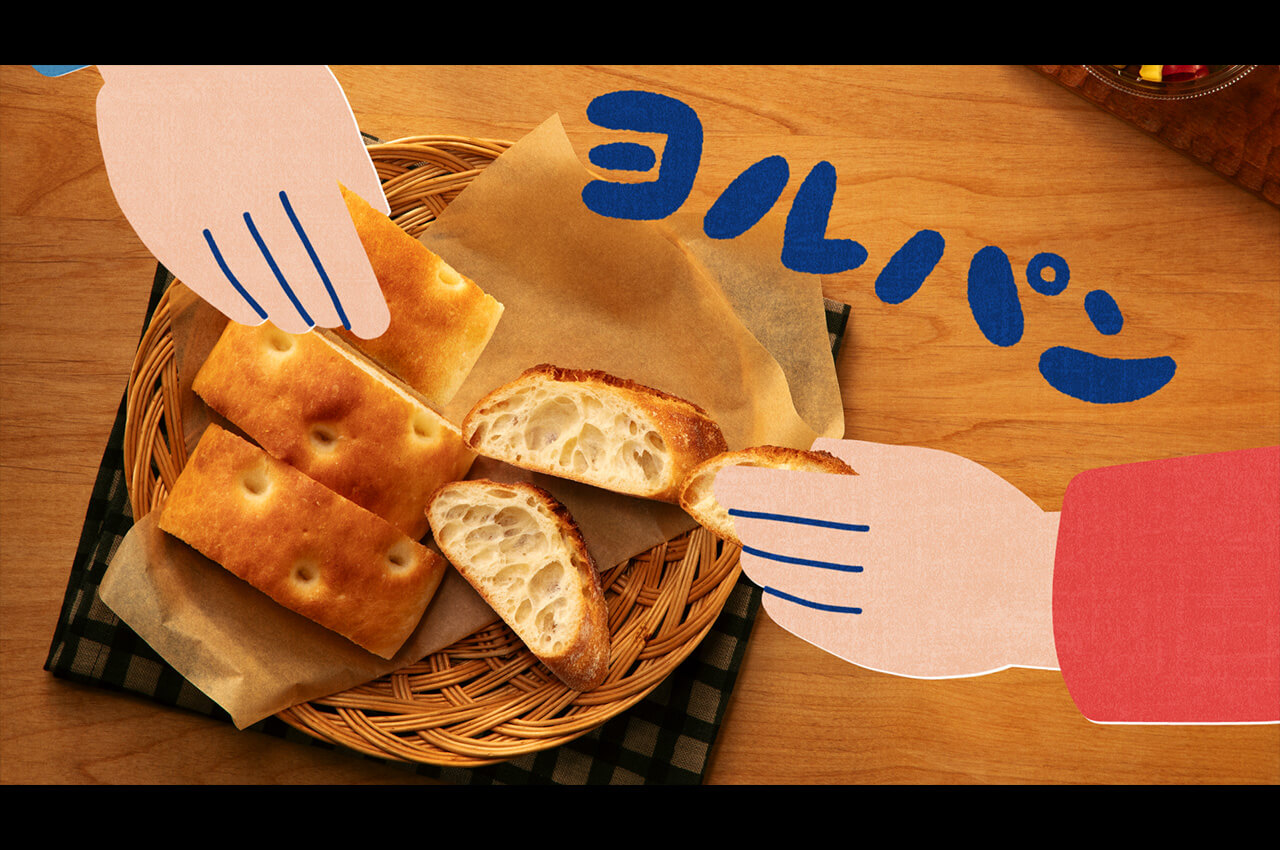 ヨルパンの文字とともに、パンを手に取るイラスト